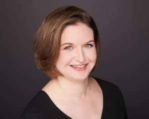 Smiling white woman wearing a black shirt